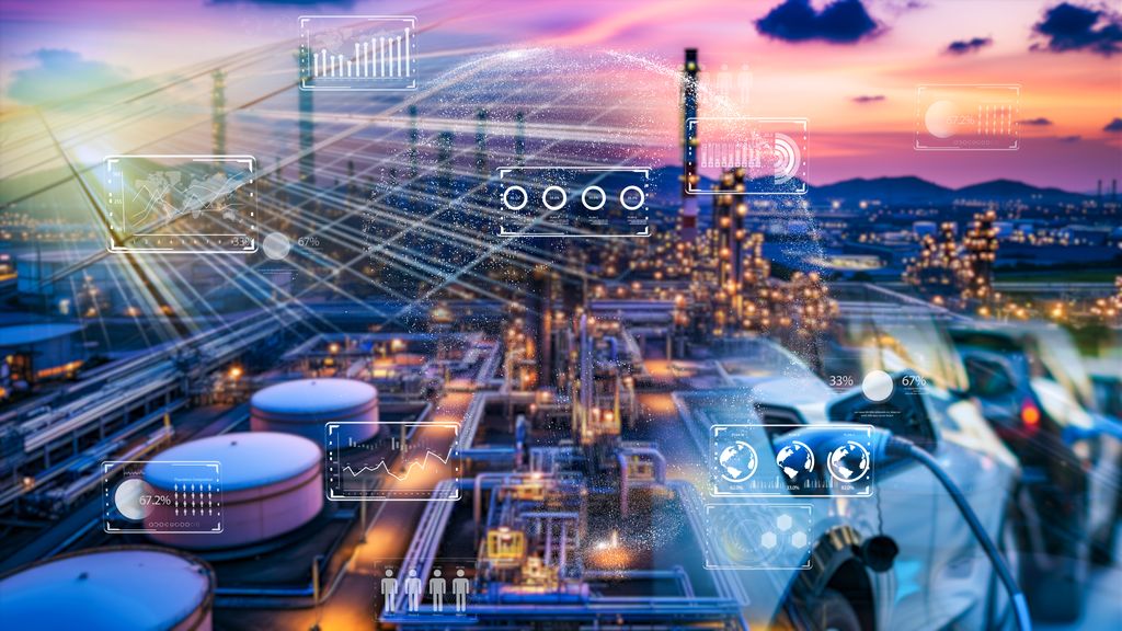 An industrial complex at dusk with overlaid digital graphics symbolising the integration of virtual and digital twin technology in monitoring and optimising facility operations.