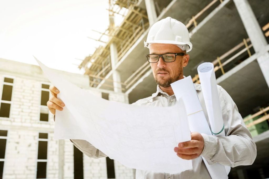 Construction Project Manager Reviewing Residential Development Plans Construction project manager reviewing plans for a major residential development.